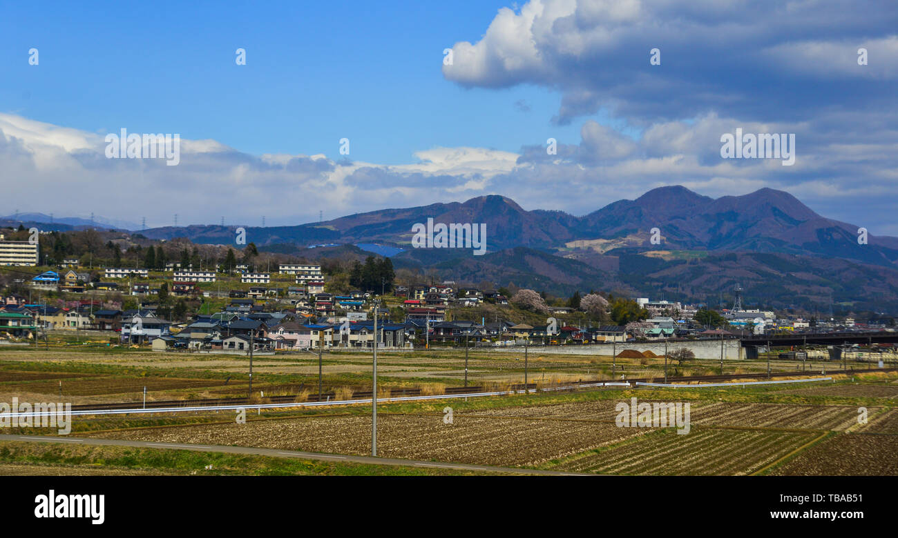 Small town with snow mountain in Fukushima, Japan. Fukushima is the place where the nuclear disaster occurred in 2011. Stock Photo