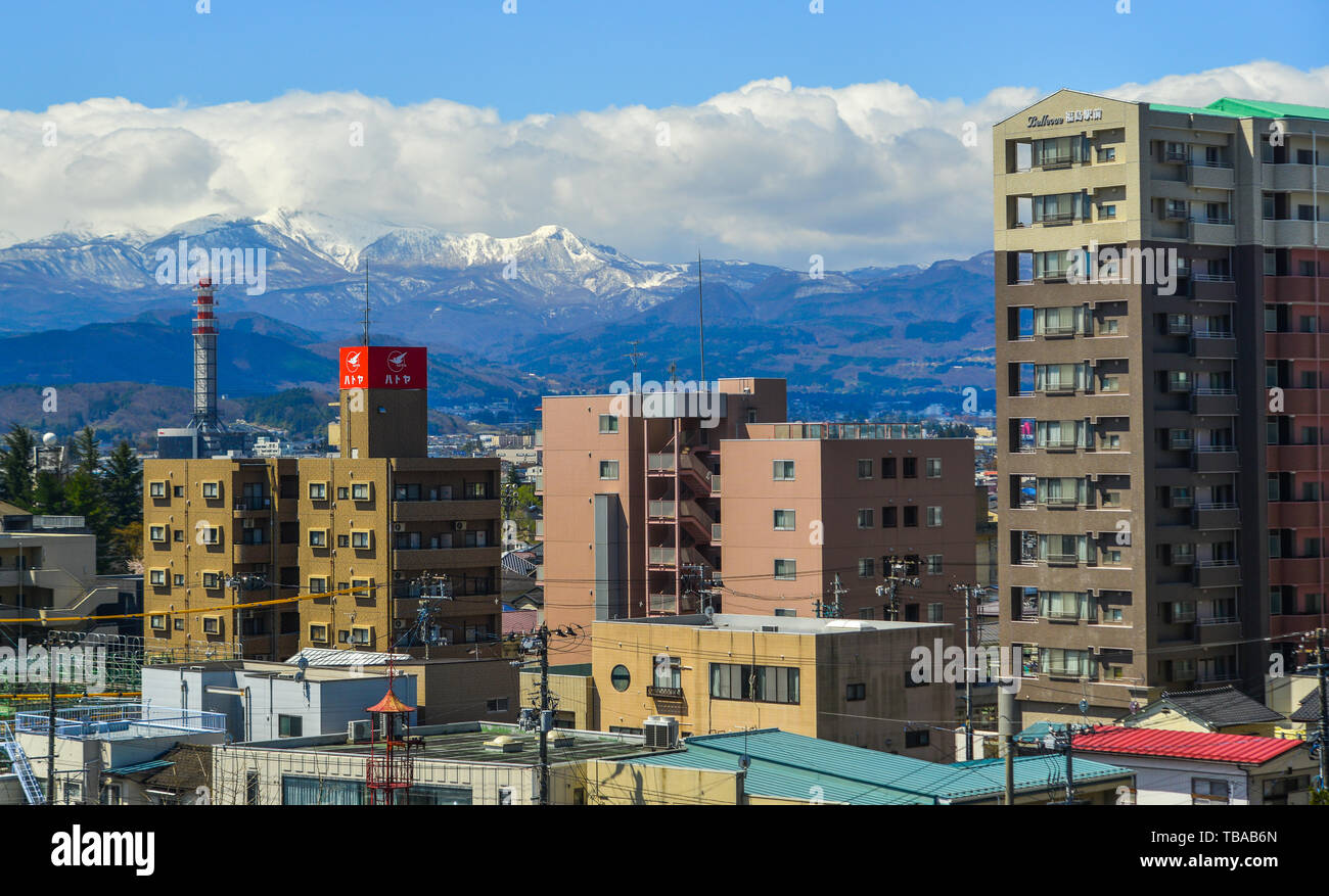 Fukushima, Japan - Apr 15, 2019. Cityscape with snow mountain in Fukushima, Japan. Fukushima is the place where the nuclear disaster occurred in 2011. Stock Photo