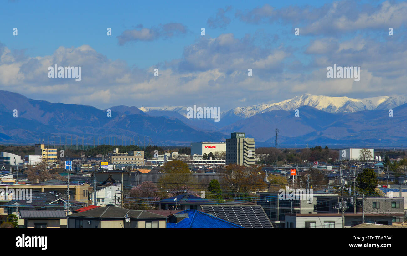 Fukushima, Japan - Apr 15, 2019. Cityscape with snow mountain in Fukushima, Japan. Fukushima is the place where the nuclear disaster occurred in 2011. Stock Photo