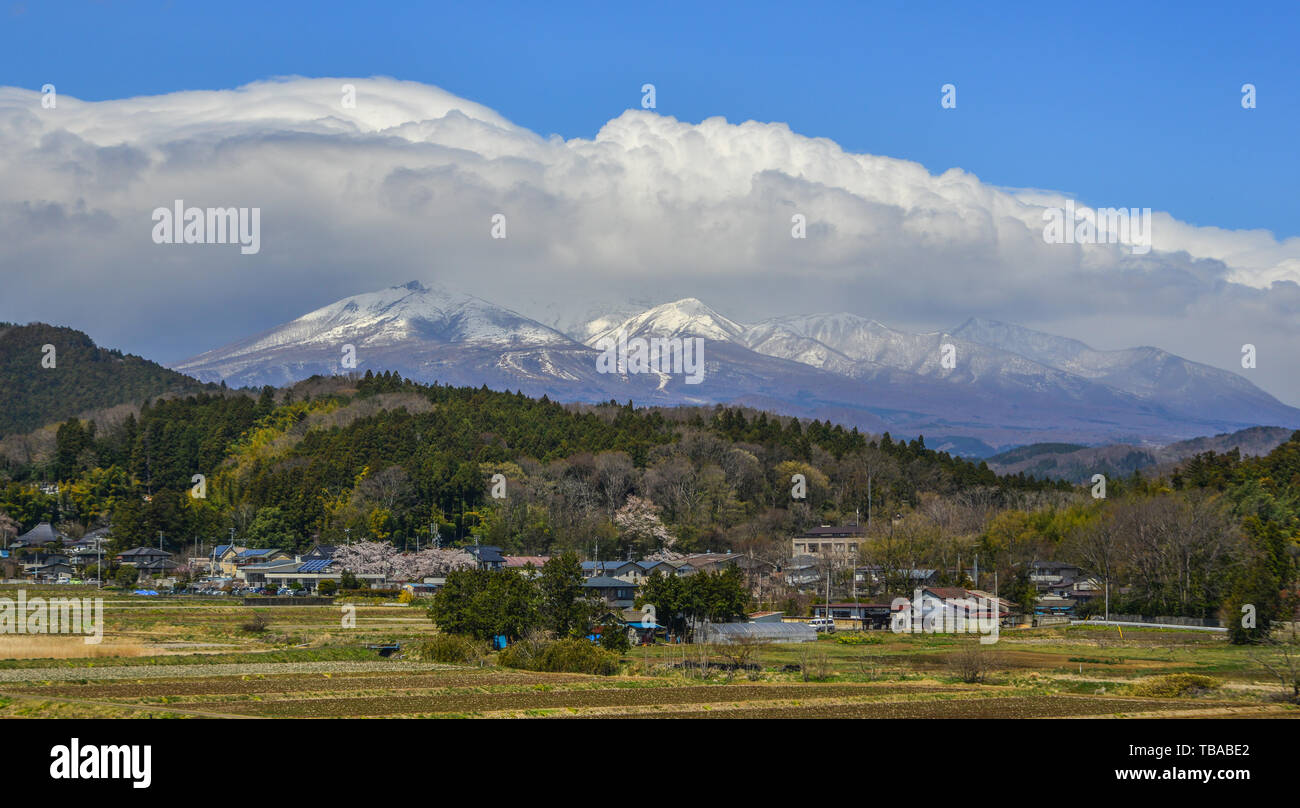 Small town with snow mountain in Fukushima, Japan. Fukushima is the place where the nuclear disaster occurred in 2011. Stock Photo