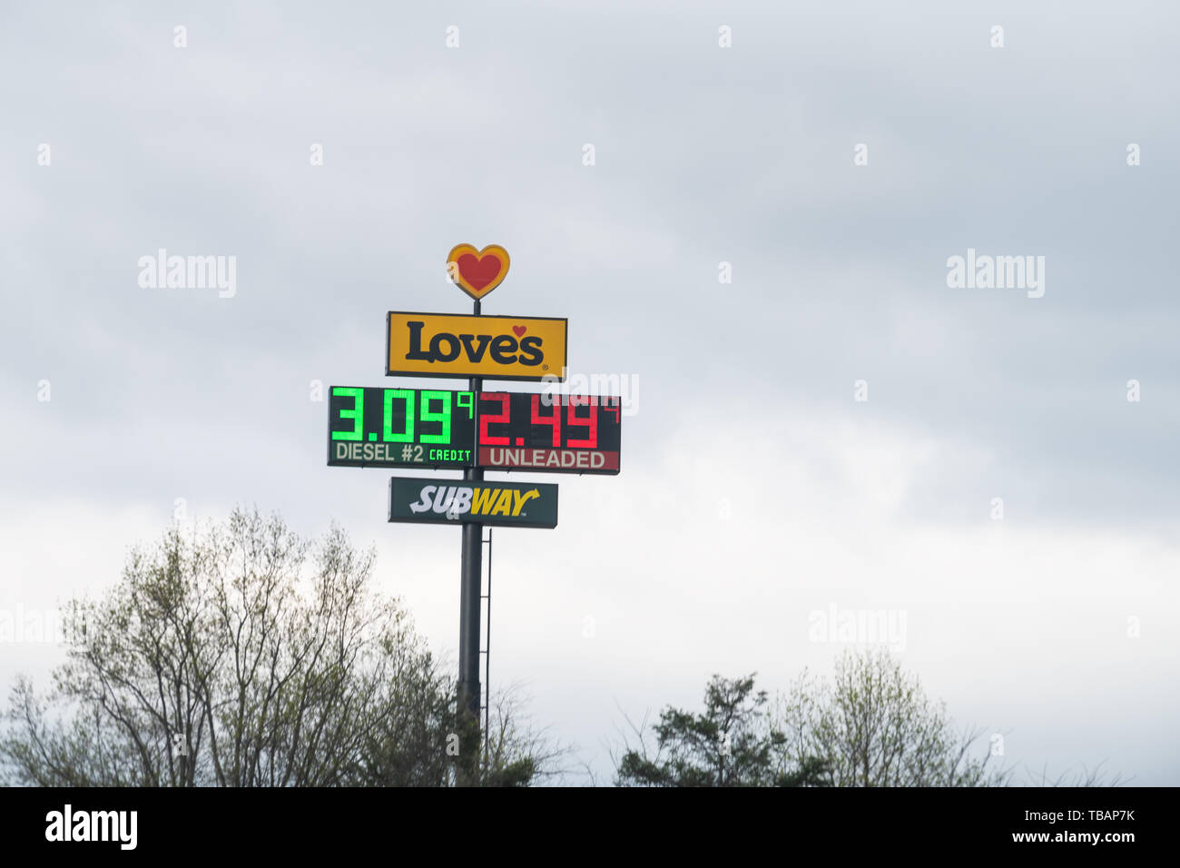 Wytheville, USA - April 19, 2018: Road street during day in city with closeup of Love's gas station light screen with price and subway fast food resta Stock Photo