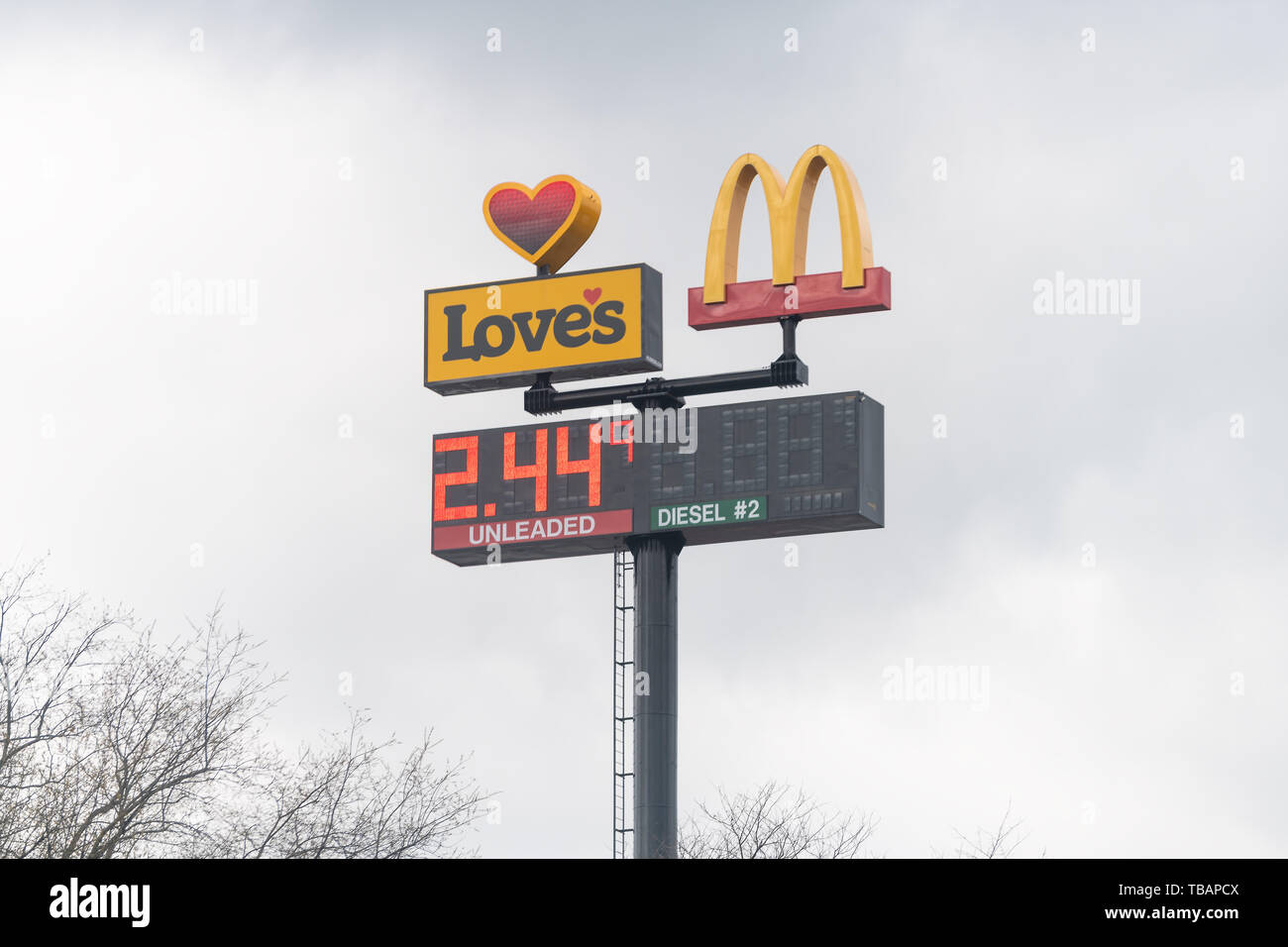 Meadowview, USA - April 19, 2018: Road street during day with closeup of Love's gas station light screen with price and McDonald's fast food restauran Stock Photo