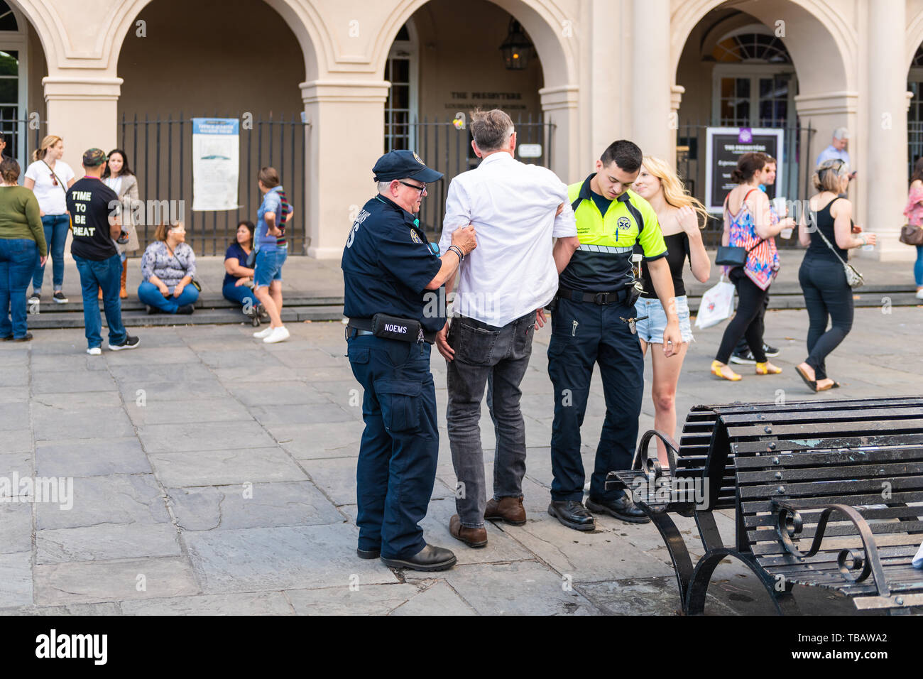 New Orleans, USA - April 22, 2018: Jackson Square in Louisiana city town during day with EMS security police guard officer arresting man Stock Photo