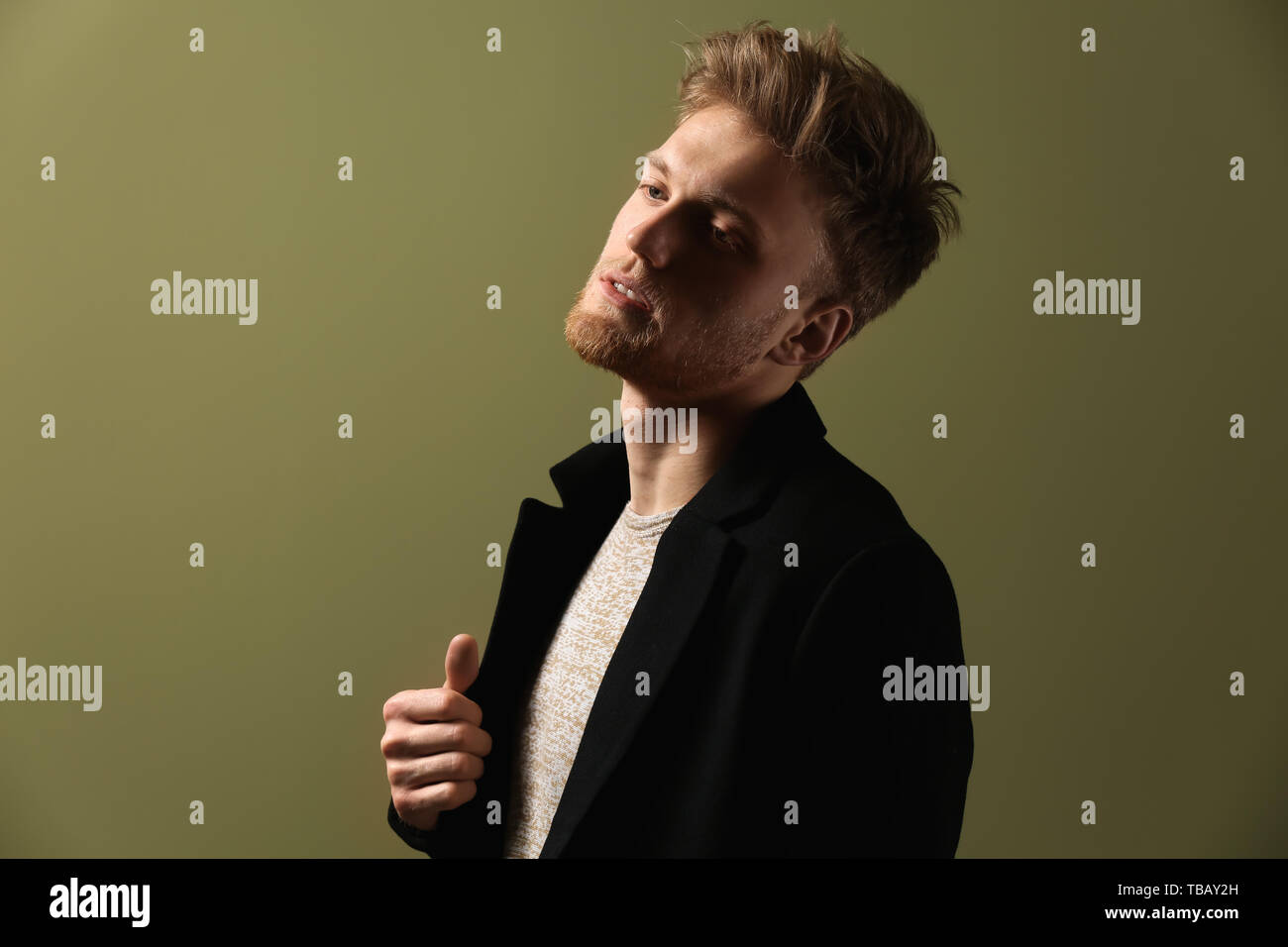 Fashionable young man on color background Stock Photo