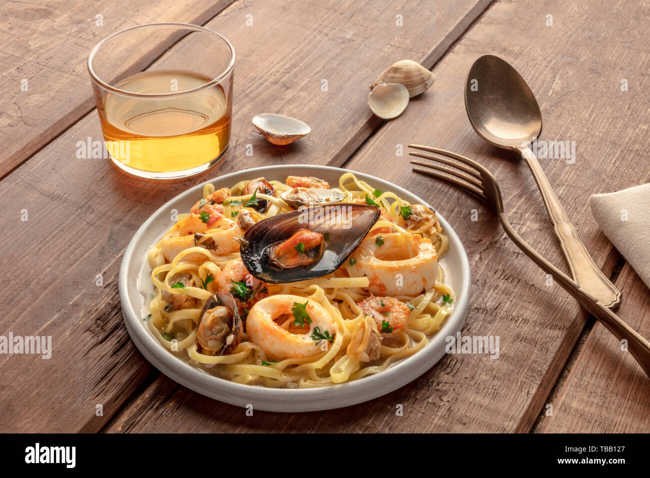 Seafood pasta. Tagliolini with mussels, shrimps, clams and squid rings