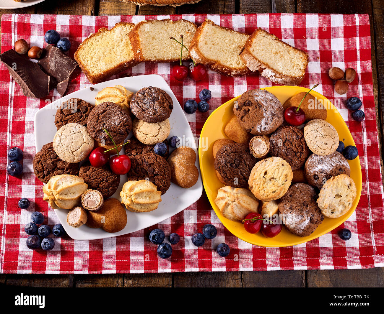 Oatmeal Cookies and sand chocolate cake with blueberries sun flare Stock Photo