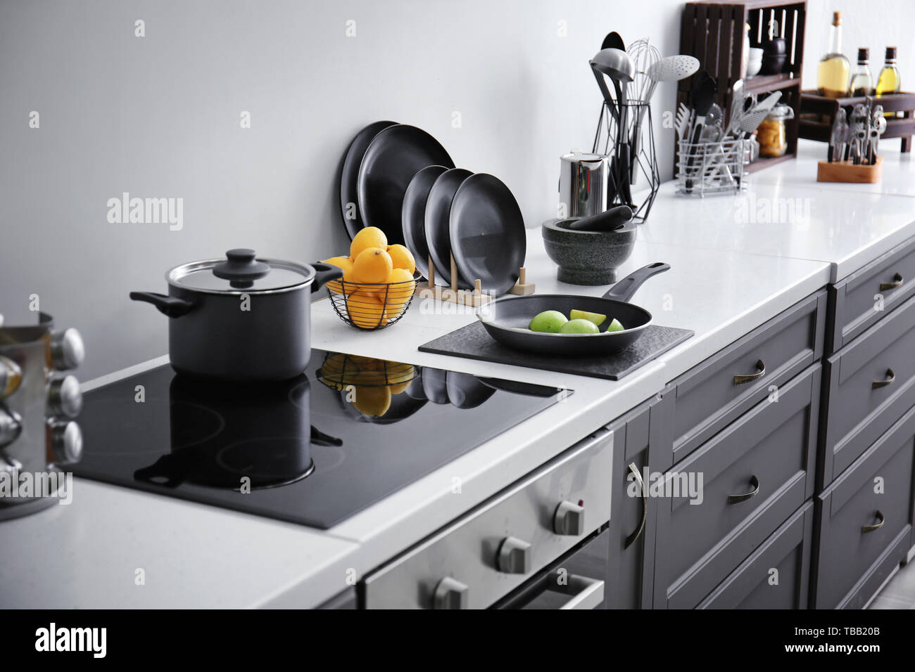 Clean utensils with products on counter in modern kitchen Stock Photo