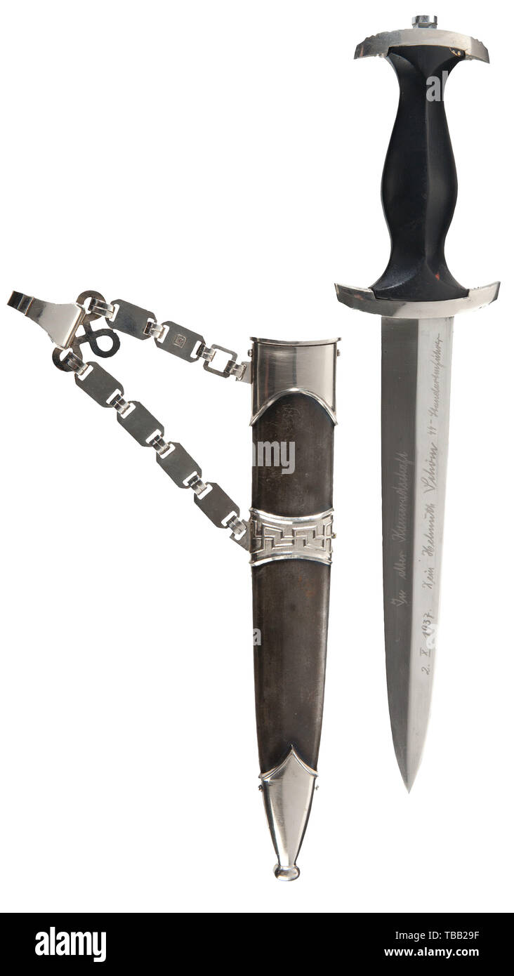 THE JOHN PEPERA COLLECTION, SS-Standartenführer Helmuth Schön - a M 1936 SS presented service dagger, with chain hanger, Polished blade (greying) with etched motto. Reverse etched with 'In alter Kamradschaft 2. X. 1937 Dein Helmuth Schön SS Standartenführer' (tr. 'To old comradeship, October 2, 1937 yours Helmuth Schön SS-Colonel'). Nickel-plated hilt fittings. Restored black ebony wooden grip with inset nickel silver eagle and enamelled SS-emblem. Service worn restored black burnished steel scabbard with nickel-plated fittings. Nickel-plated type I chain hanger with stampe, Editorial-Use-Only Stock Photo