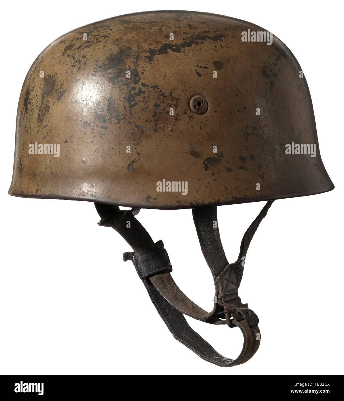 A helmet for paratroopers In typical paint for members of the Afrika Korps and southern front. The skull with ca. 80% intact original paint, the interior stamped 'ET68' and '1421', four cheese-head screws with ventilation openings and two holes for the pin wrench. Aluminium inner ring with light rubber padding, the leather lining discoloured due to wear, with ink stamping 'Kopfgröße 57 - Stahlhaube 68' as well as designation 'Karl Helsler, Berlin C.2.' and 'D.R.G.M.S.'. The liner with hand-written name initials 'M.W.'. The leather strapping of th, Additional-Rights-Clearance-Info-Not-Available Stock Photo