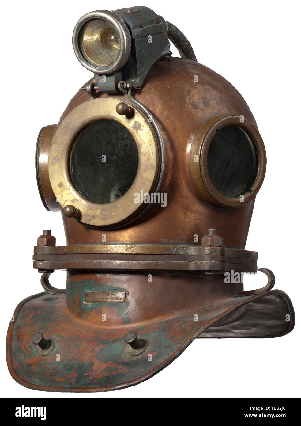 A Russian diving suit Helmet dated 1946. Copper diving helmet with screw-mounted three bolt-system, three brass helmet windows and mounted diving lamp. Helmet and collar with different numbers, the helmet stamped with the date '1946'. Diving suit of rubberised fabric with gloves, the weighted shoes with lead sole and lace fastening. Top of the helmet slightly dented. Height of helmet with collar and lamp 52 cm. historic, historical, 20th century, Additional-Rights-Clearance-Info-Not-Available Stock Photo