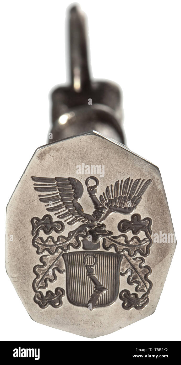 Hermann Göring - a silver seal with his family's coat of arms In the shape of the armour-clad arm from Göring's coat of arms, the ring with the fineness mark '925' next to a crescent moon, crown and 'ZH', the master mark of Prof. Herbert Zeitner, the surface decorated with fine hammer marks. Cut into the seal matrix the large helmeted coat of arms of Hermann Göring. Total height 103 mm, weight 177 g. With a confirmation of Göring's favourite jeweller, Prof. Herbert Zeitner, stating that 20 such seals were made according to Hermann Göring's design for his various offices and, Editorial-Use-Only Stock Photo