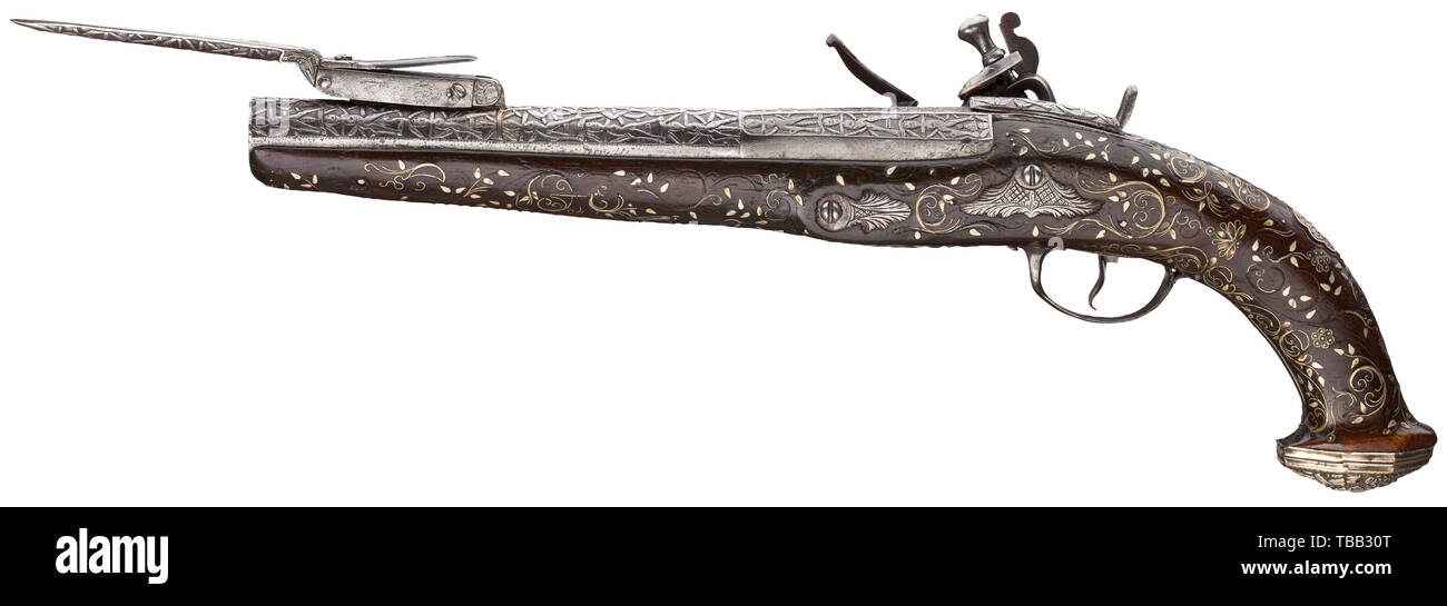 A flintlock pistol with spring-loaded bayonet, colonial work, 19th century Two-stage smooth-bore barrel, octagonal then round, in 15 mm calibre, on top a spring-loaded bayonet. The mechanism of the flintlock is slightly fatigued. Barrel, bayonet and lock completely chiselled with anthropomorphic figures. Dark full stock with floral nickel silver inlays, iron furniture and silver grip caps in fine relief. Length 37.5 cm. historic, historical, civil handgun, civil handguns, handheld, gun, guns, firearm, fire arm, firearms, fire arms, weapons, arms,, Additional-Rights-Clearance-Info-Not-Available Stock Photo