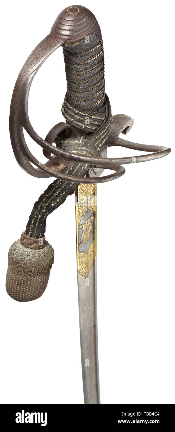 A Damascus sabre M 1881 for an officer of the artillery Slightly curved, somewhat stained pipe-backed blade of wild Damascus, gilt etchings on both sides ('FAR' = King Frederick Augustus III as well as 'Eisenhauer' and 'Damast-Stahl' with Royal Saxon coat of arms), the reverse with Z-shaped maker's mark (Neuhaus, Solingen), on the back an etched purveyor's signature 'Otto Graf Leipzig Gohlis'. Iron basket hilt with one finger hook, sharkskin grip and triple wire wrap. Attached sword knot with green interweaves (damaged). Black lacquered steel sca, Additional-Rights-Clearance-Info-Not-Available Stock Photo
