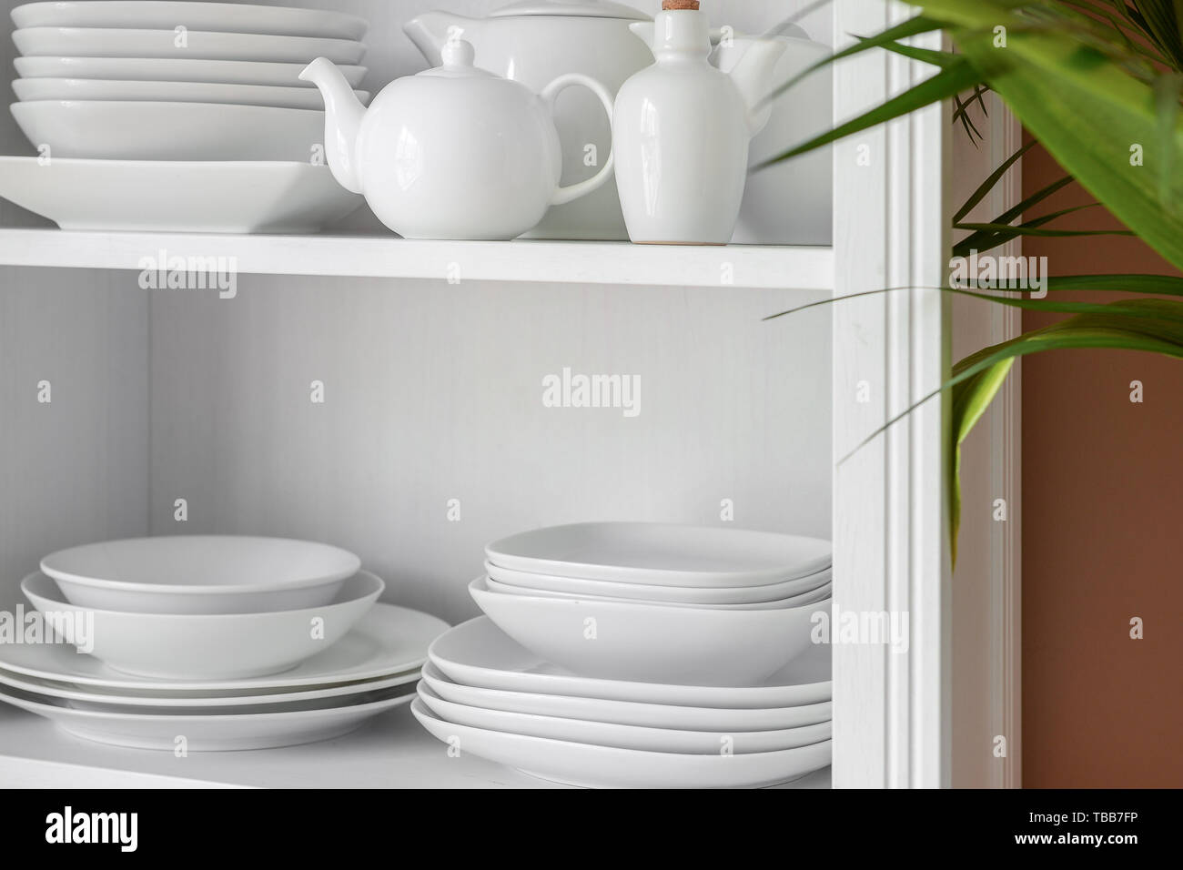 Set of clean dishes on shelves in kitchen Stock Photo Alamy