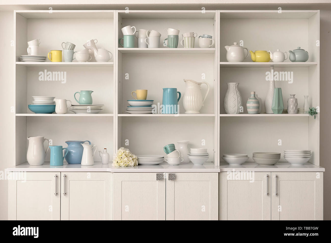Cupboard with clean dishes in kitchen Stock Photo Alamy