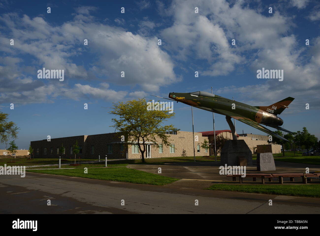 A U.S. Air Force F-100 Super Saber is displayed in front of the new consolidated support facility at the Iowa Air National Guard’s 185th Air Refueling Wing in Sioux City, Iowa on May 30, 2019. The 37,000-square-foot, $12.4 million dollar structure is the new home for the unit’s clinic, food services, communications function and public affairs office.  The new construction is a first for each of the unit’s tenants, in that the building has been designed and built specifically for these military functions.   U.S. Air National Guard photo by Senior Master Sgt. Vincent De Groot 185 ARW PA Stock Photo