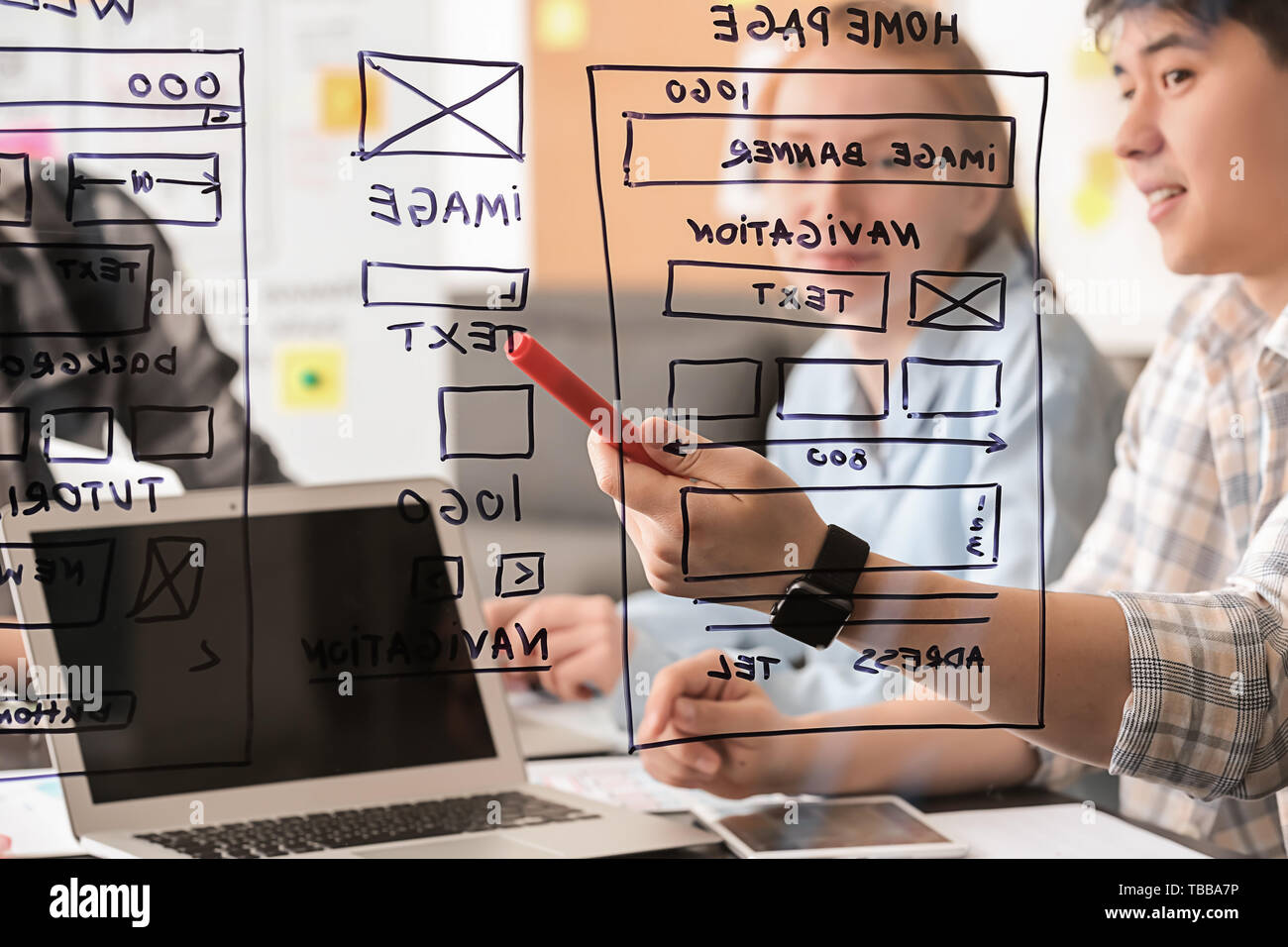 IT designers discussing project, view through transparent board Stock Photo
