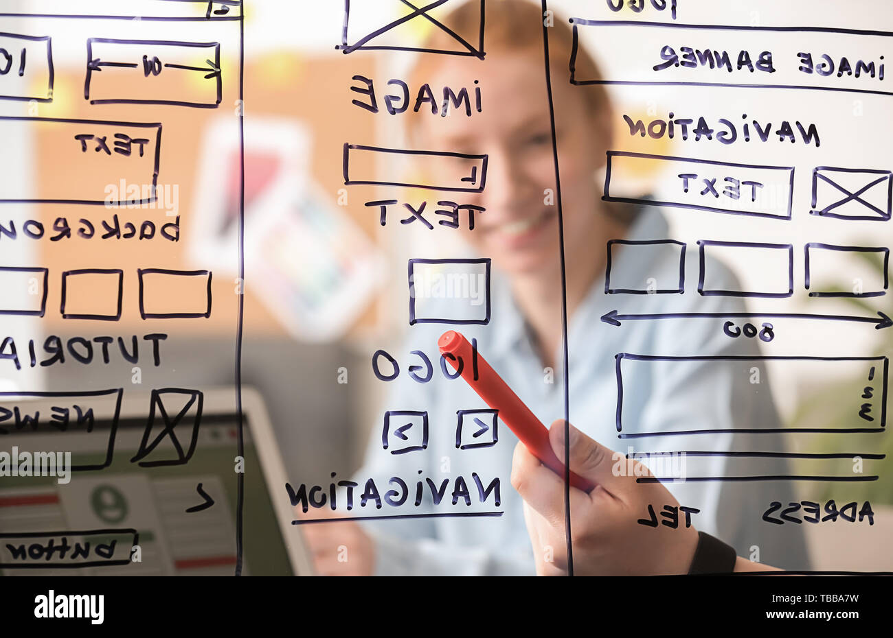 IT designers discussing project, view through transparent board Stock Photo
