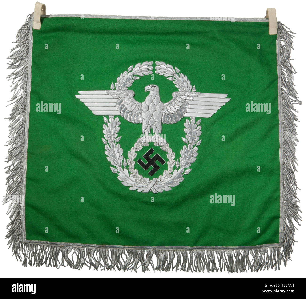 THE JOHN PEPERA COLLECTION, A Trumpet Banner of the Police, Double sided bright green doe skin wool with two 16 mm white leather attachment steel buckle straps. 8 mm flat silver bordering outer edge with 4.5 cm silver/aluminium wire fringe on three sides. Embroidered police eagle with outstretched wings, clutching a wreathed, canted woven black thread swastika in its talons, encompassed by a vertically oval, oakleaf wreath in silver/aluminium metal thread. Dimensions 44.5 x 47 cm (without fringe). Superb quality., Editorial-Use-Only Stock Photo