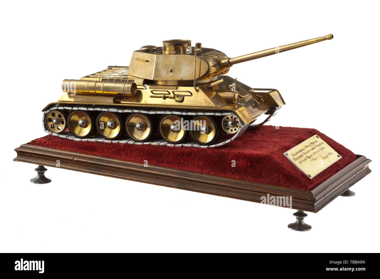 A T 34 tank model as a gift of honour to the Nationale Verteidigungsrat der DDR (East German National Defence Council) from 1960, Brass, shining like gold, polished and varnished. Rotatable turret, movable antenna, indicated front machine gun, movable tracks (rubber coating, light metal chains). On presentation pedestal covered with red velvet-like material a dedication plaque with Cyrillic engraving (tr.) 'To the National Defence Council of East Germany from the Soviet troops stationed in Germany, November 1960'. Handled with great care, light usage and age marks. Displaye, Editorial-Use-Only Stock Photo
