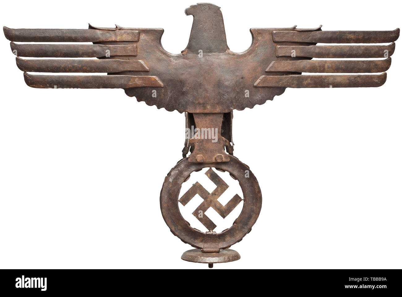 A large wrought-iron national eagle, Eagle with antique bronze patina in half relief. High quality smithery using detailed-chased iron sheets with separately applied feathers, wings, claws and oak leaf wreath with swastika. Complete with fastening threads and intermediary plate, also of wrought iron. Height circa 58 cm, wing span circa 91 cm. historic, historical 20th century, Editorial-Use-Only Stock Photo