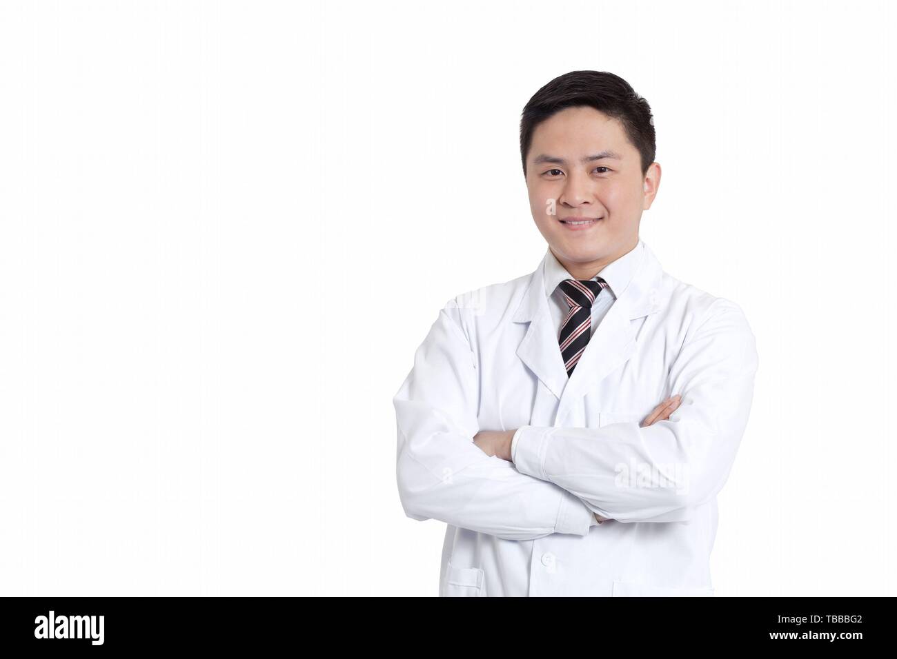 Happy young doctor crossed arms hi-res stock photography and images - Alamy