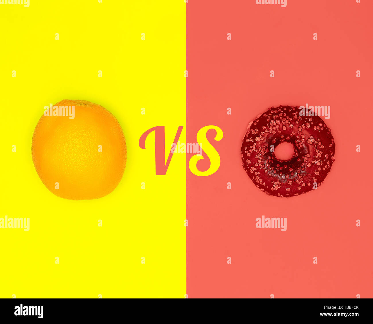 Healthy food vs harmful snacks. Choice concept. Orange and Donut. Living coral flat lay Stock Photo