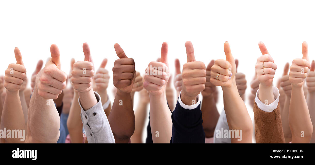 Close-up Of People's Hand Showing Thumb Up Sign Against Isolated On ...