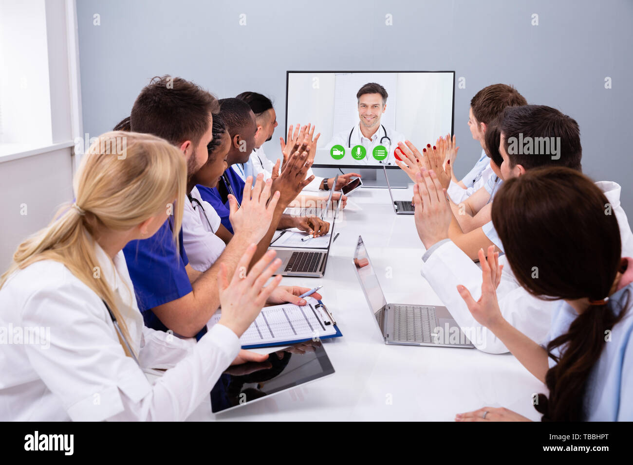 Professional Team Of Multi-ethnic Medical Doctors Having A Video Conference Stock Photo