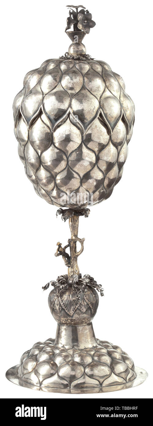 A large German pineapple goblet, probably Hanau, circa 1860 Silver, partly gilt. Foot with chased studs and vegetal decorations. The stem in the form of a tree trunk with the figure of a woodcutter. The bowl and the lid with finely worked decorative studs, the pommel with blossoms and vegetal decorations. The foot punched with '13' and an indistinct master's punch mark. Height 37.5 cm, weight 639 g. historic, historical, handicrafts, handcraft, craft, object, objects, stills, clipping, clippings, cut out, cut-out, cut-outs, 19th century, Additional-Rights-Clearance-Info-Not-Available Stock Photo