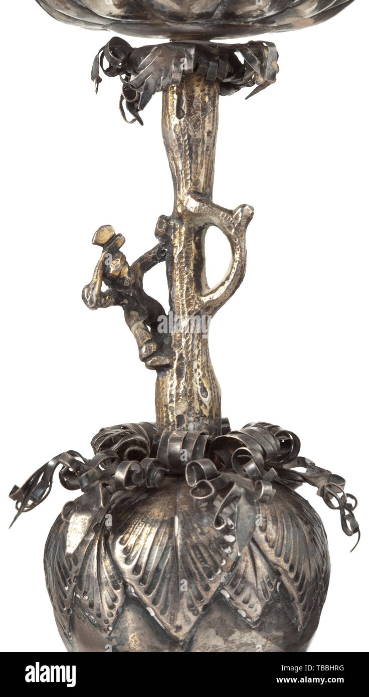 A large German pineapple goblet, probably Hanau, circa 1860 Silver, partly gilt. Foot with chased studs and vegetal decorations. The stem in the form of a tree trunk with the figure of a woodcutter. The bowl and the lid with finely worked decorative studs, the pommel with blossoms and vegetal decorations. The foot punched with '13' and an indistinct master's punch mark. Height 37.5 cm, weight 639 g. historic, historical, handicrafts, handcraft, craft, object, objects, stills, clipping, clippings, cut out, cut-out, cut-outs, 19th century, Additional-Rights-Clearance-Info-Not-Available Stock Photo