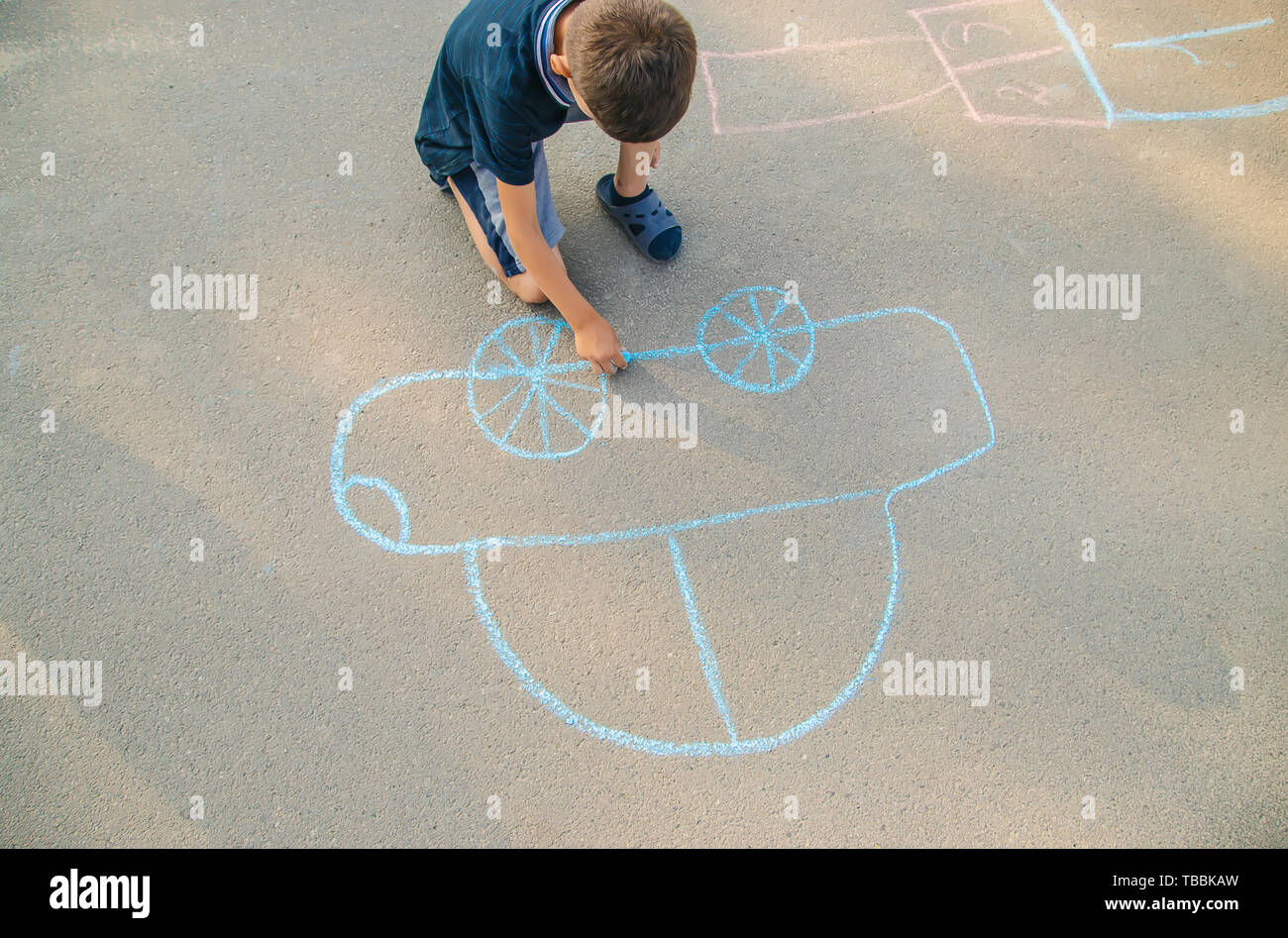 A child has used drawing chaulk to creat art on a playground Stock Photo -  Alamy