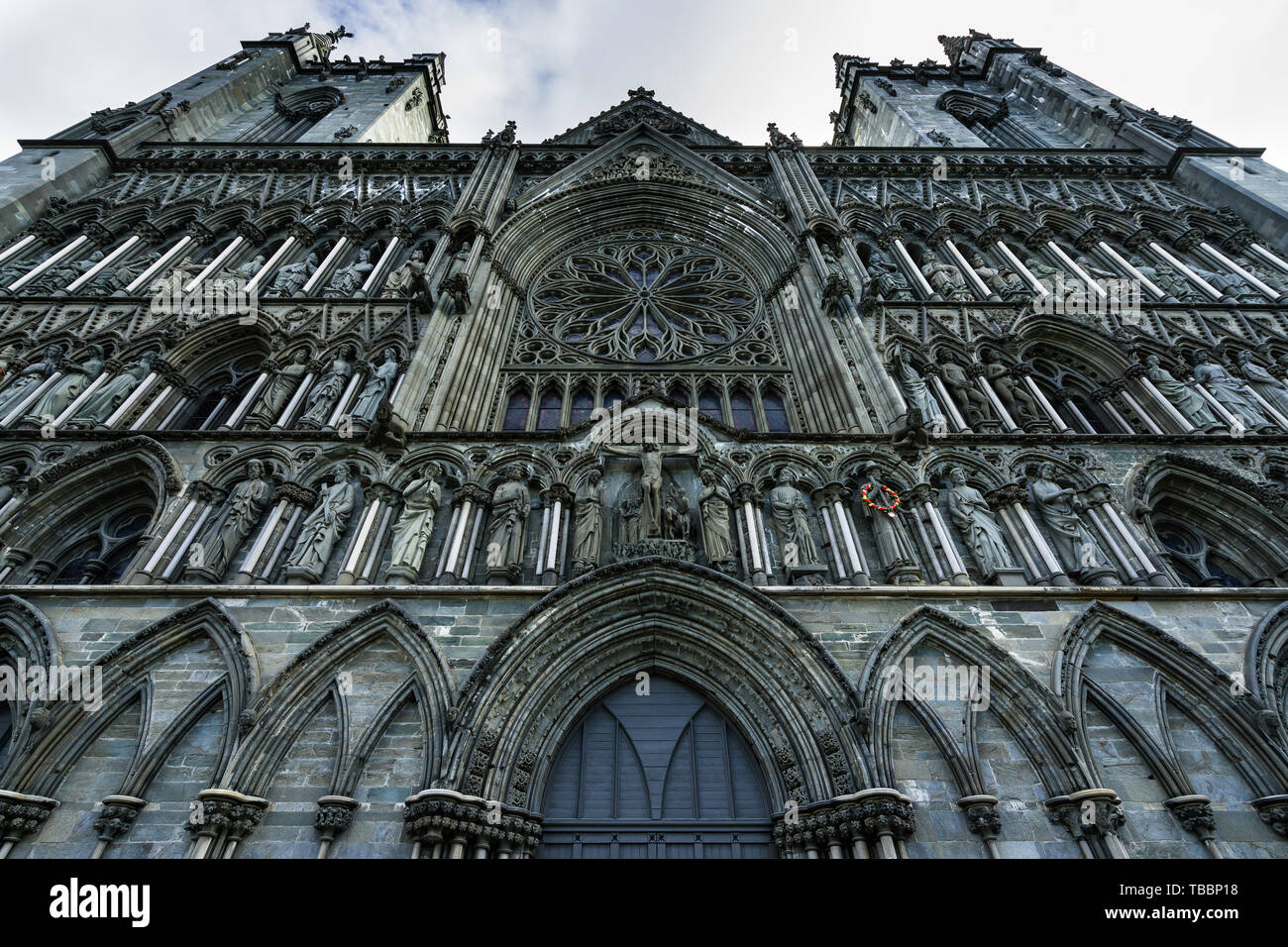 Detail of the Gothic facade of Nidaros Cathedral (Nidaros Domkirke), finely decorated with statues and ornaments Stock Photo