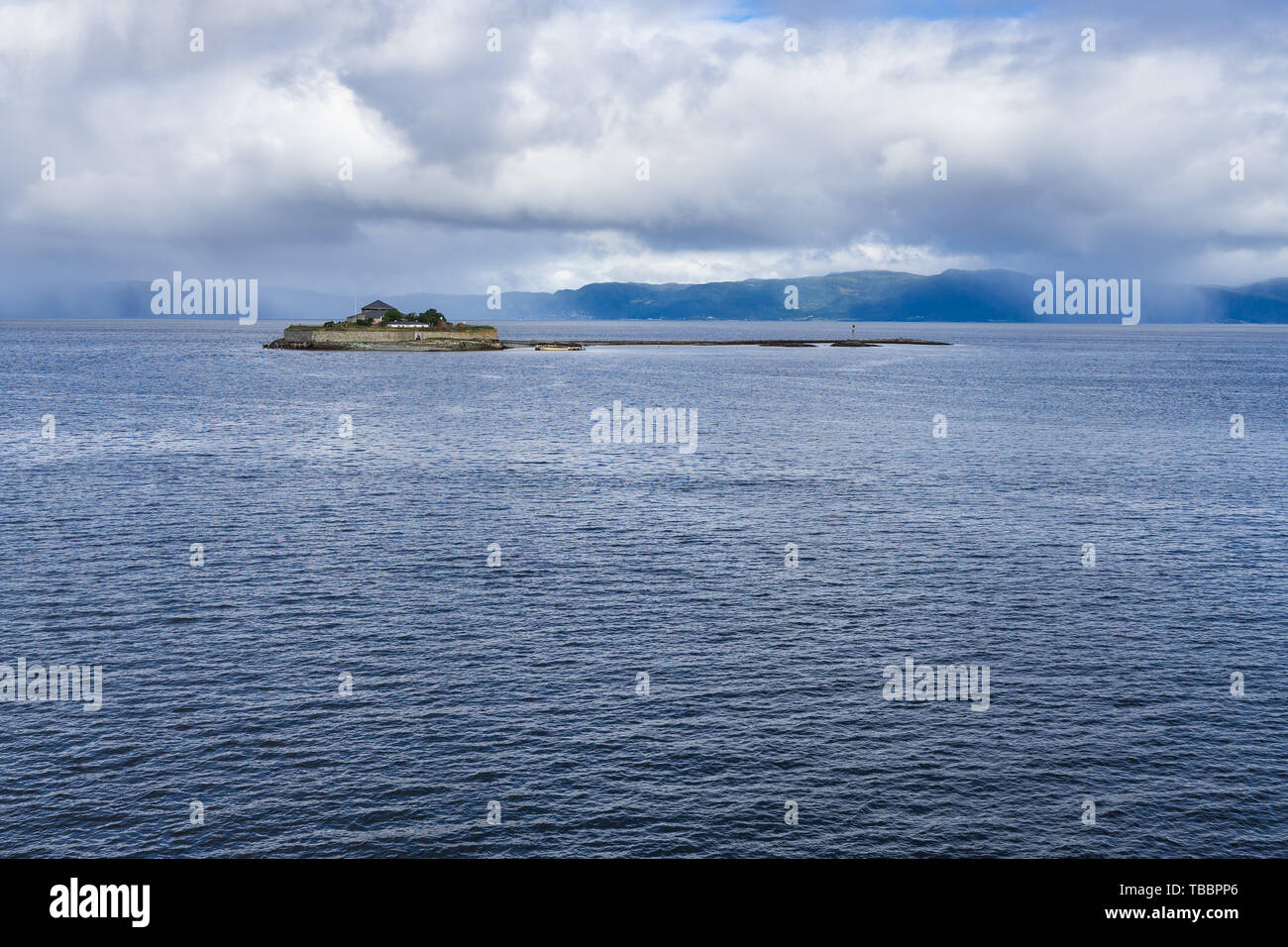 Munkholmen island in Trondheim fjord with stormy clouds in the background, Norway Stock Photo