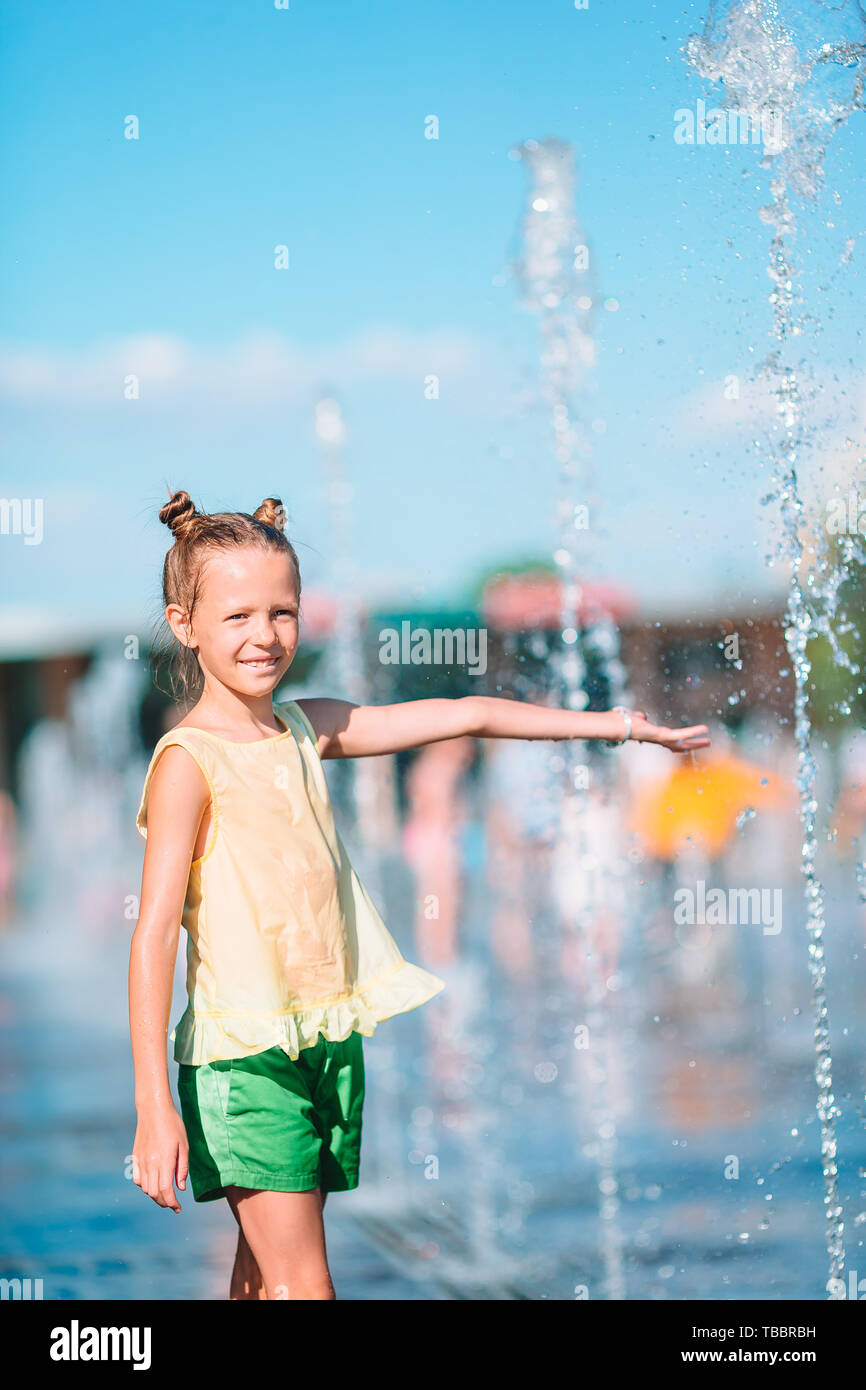 Little adorable girl having fun in street fountain at hot sunny summer day  Stock Photo - Alamy