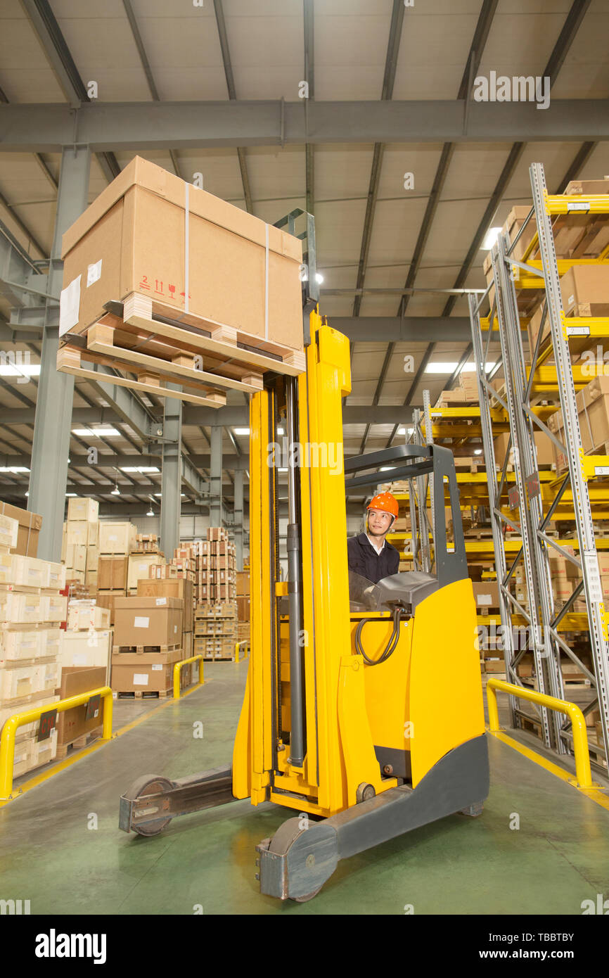 Logistics personnel load and unload cargo at the warehouse Stock Photo ...