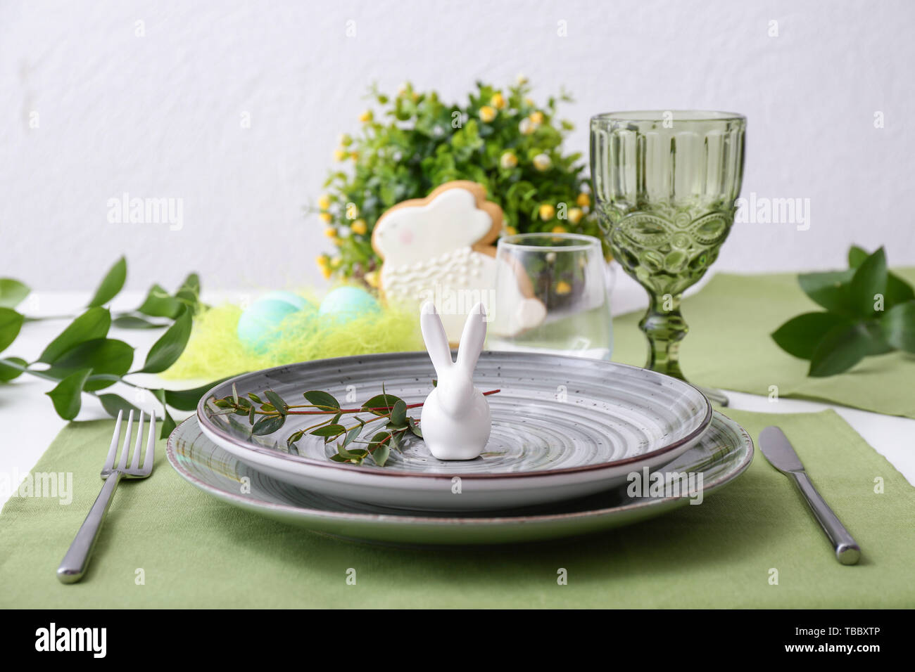 Beautiful Easter table setting with floral decor Stock Photo