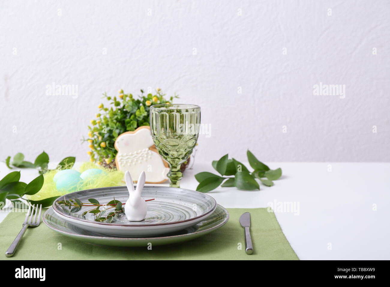 Beautiful Easter table setting with floral decor Stock Photo