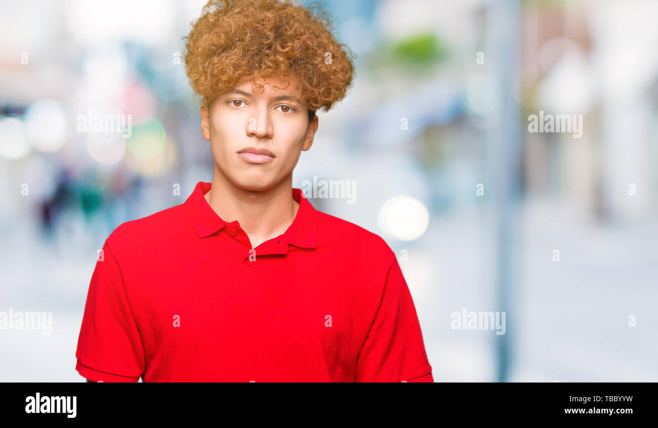Young Handsome Man With Afro Hair Wearing Red T Shirt Relaxed With