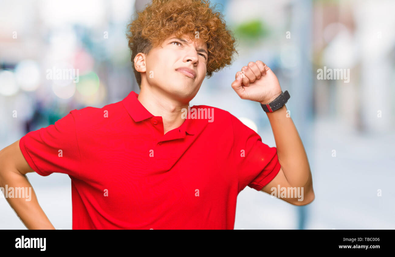 Young Handsome Man With Afro Hair Wearing Red T Shirt Stretching