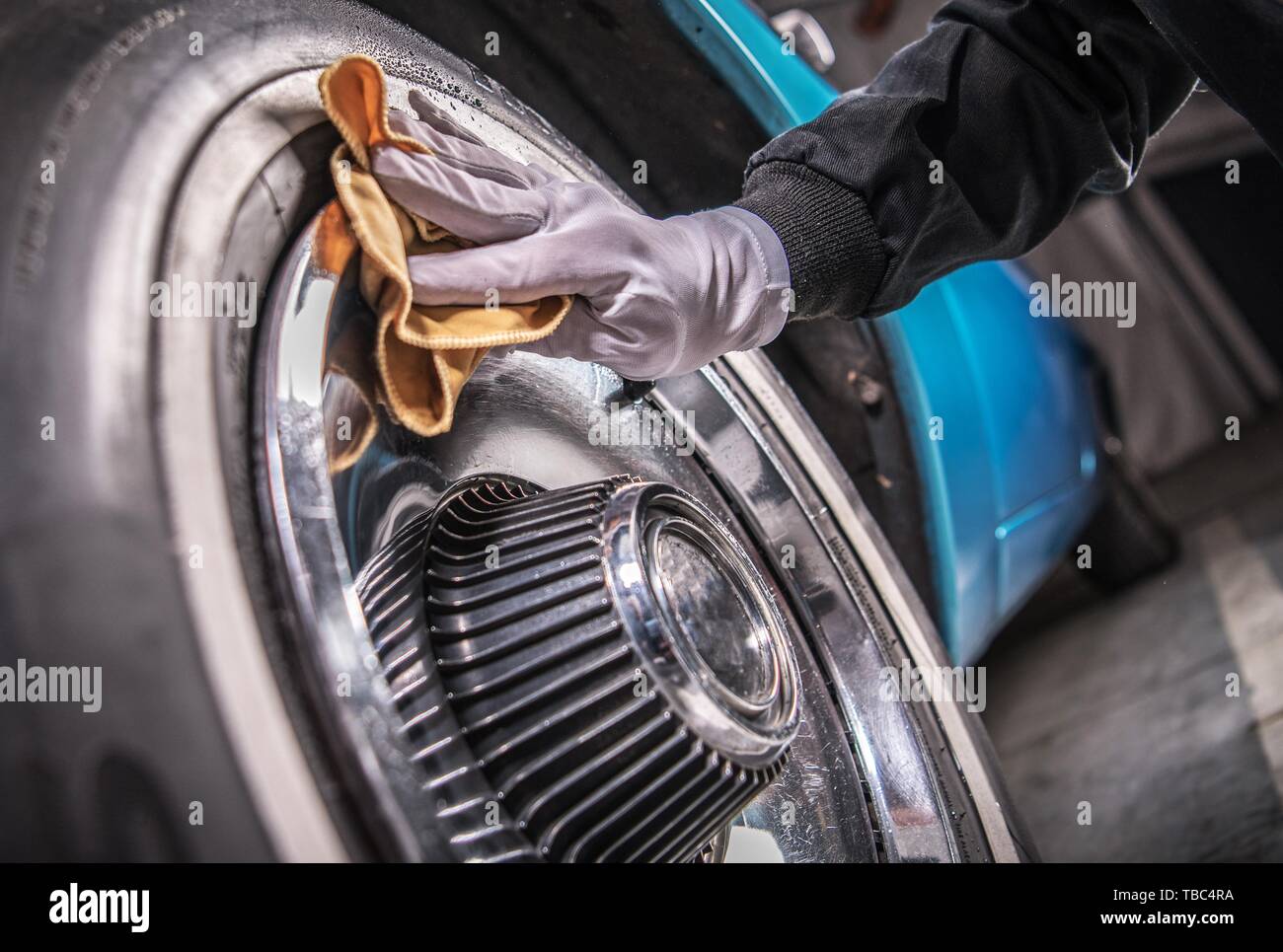 Men Cleaning Car Wheels Using Specialized Chrome Elements Detergent
