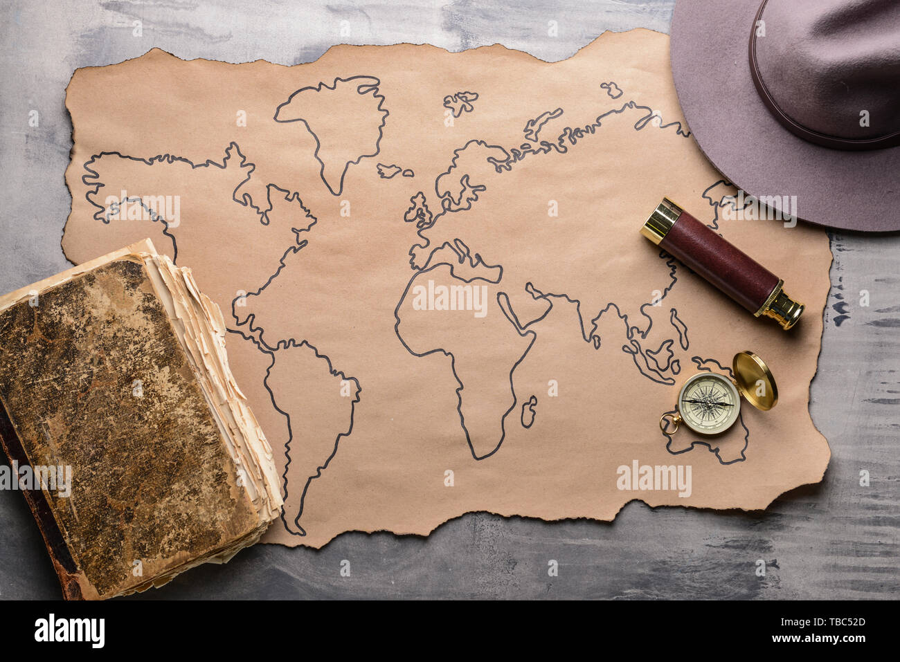 Map with compass and spyglass on grey table Stock Photo
