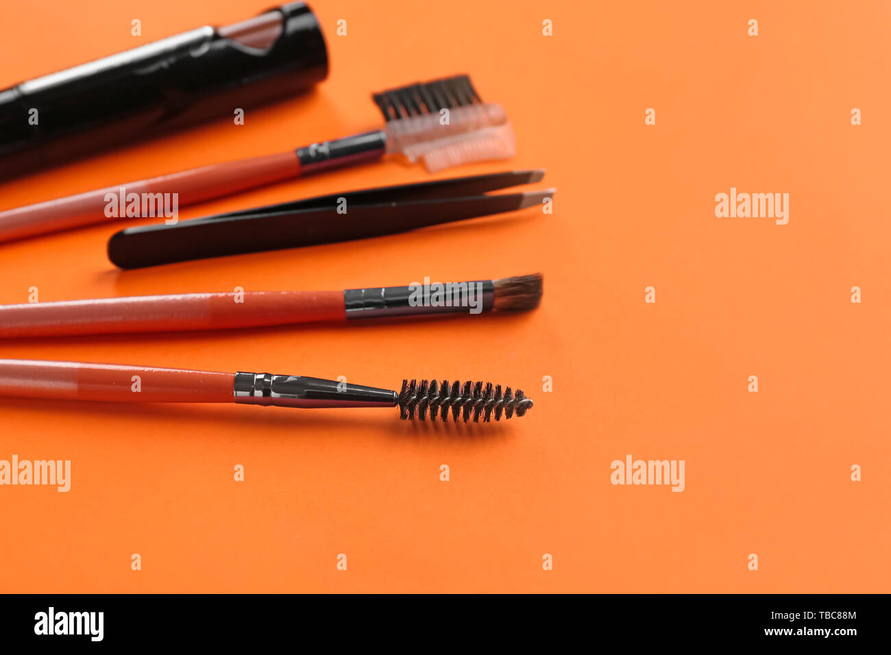 Set of tools for eyebrows correction on color background Stock Photo