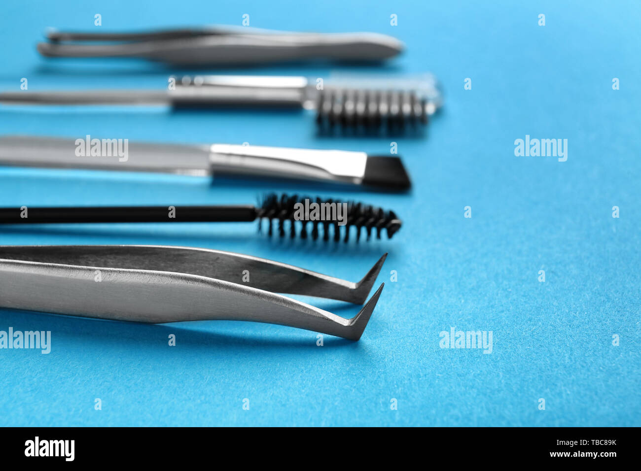 Set of tools for eyebrows correction on color background Stock Photo
