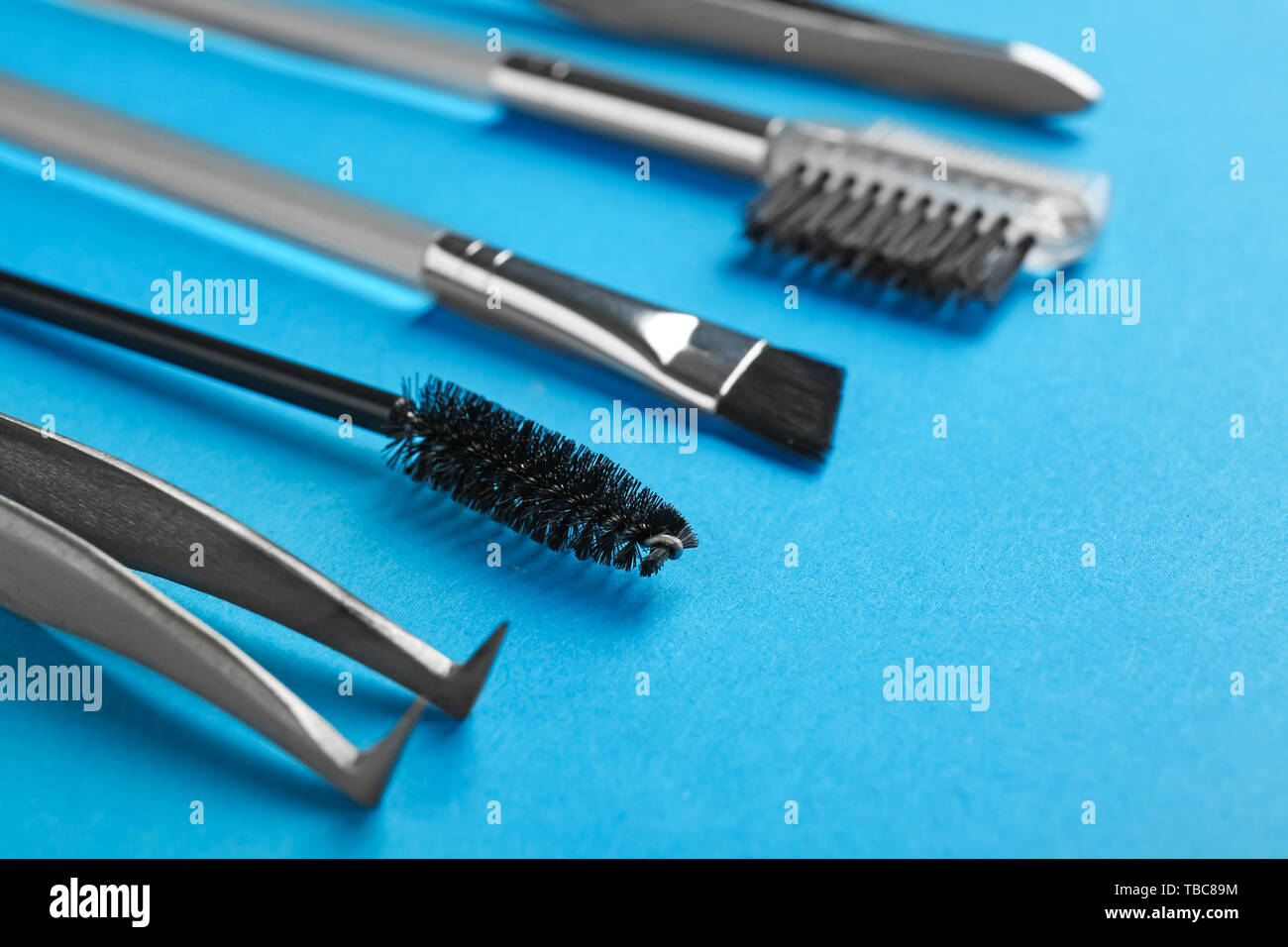 Set of tools for eyebrows correction on color background Stock Photo