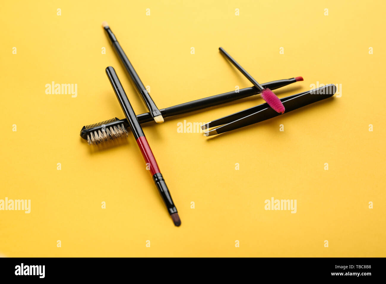 Set of tools for eyebrows correction on color background Stock Photo