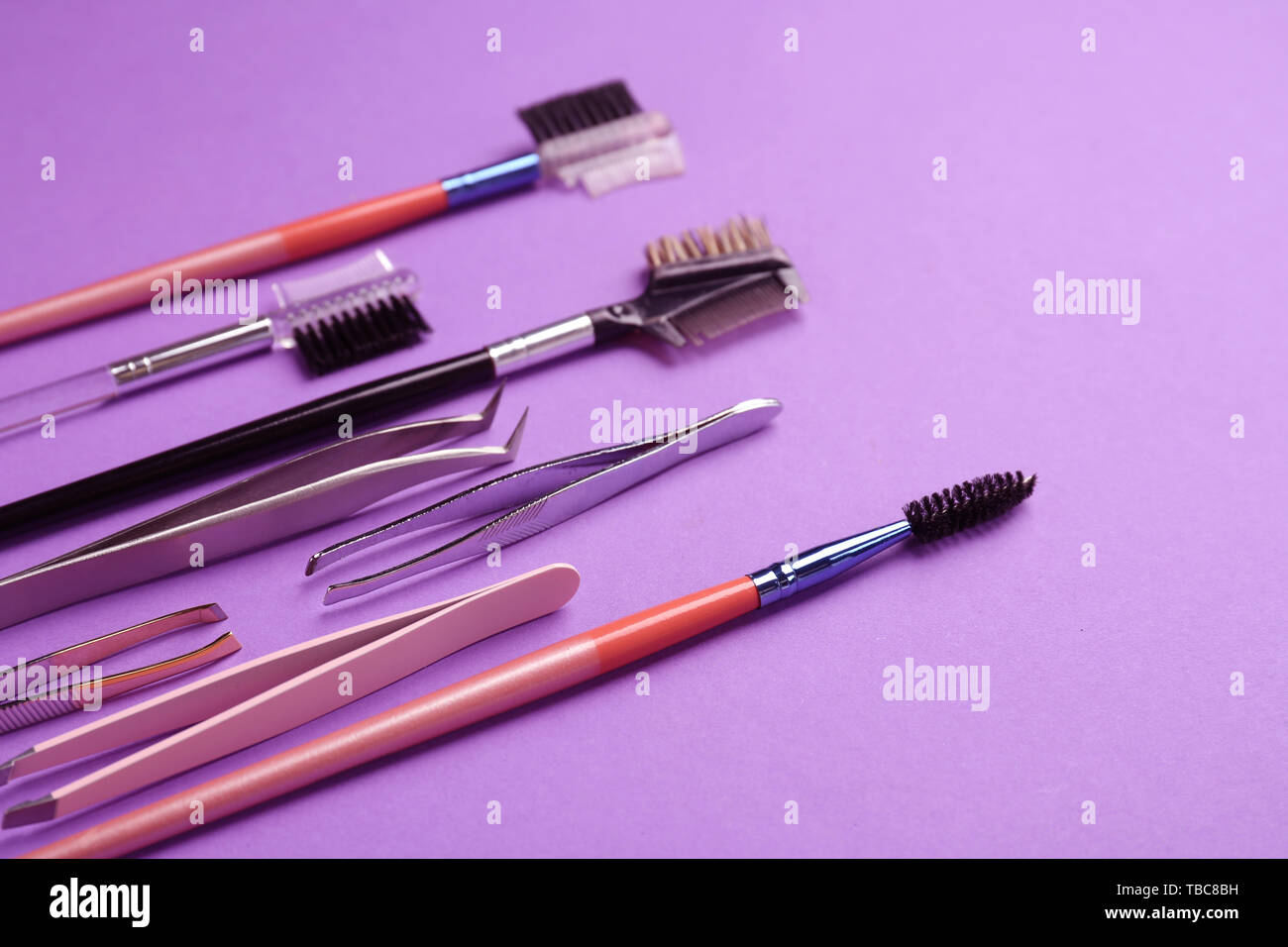 Set of tools for eyebrows correction on color background Stock Photo