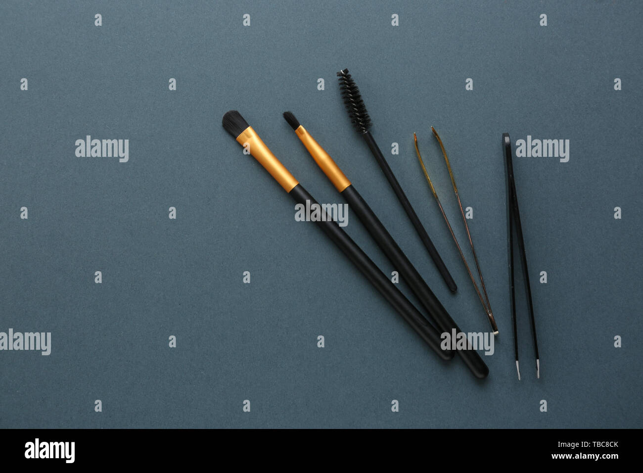 Set of tools for eyebrows correction on grey background Stock Photo