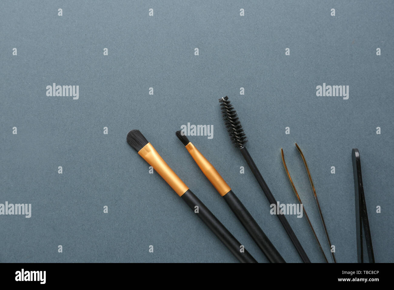 Set of tools for eyebrows correction on grey background Stock Photo