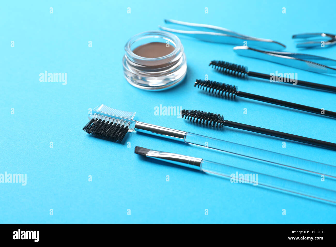 Set of tools for eyebrows correction on color background Stock Photo